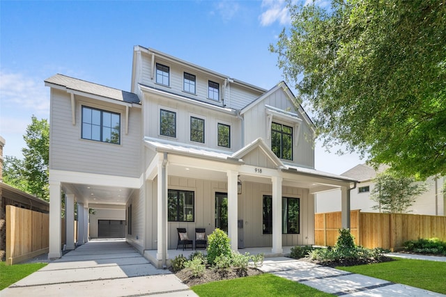 711 E 12th St, Houston, TX 77008 - modern farmhouse featuring board and batten siding, a porch, concrete driveway, and a carport
