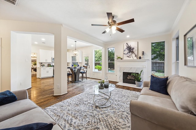 14103 Jade Meadow Ct, Houston, TX 77062 - living area with wood finished floors, a ceiling fan, crown molding, a premium fireplace, and recessed lighting