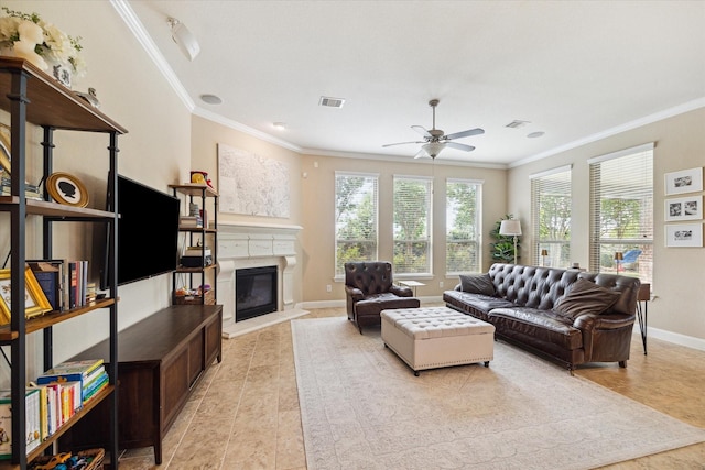 21307 Plum Gate Ct, Richmond, TX 77407 - living room with plenty of natural light, ornamental molding, ceiling fan, a glass covered fireplace, and light tile patterned flooring