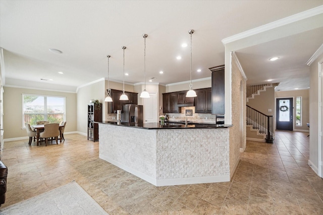 21307 Plum Gate Ct, Richmond, TX 77407 - kitchen featuring stainless steel fridge, dark brown cabinets, plenty of natural light, tasteful backsplash, and ornamental molding
