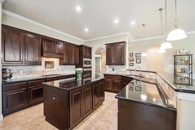 21307 Plum Gate Ct, Richmond, TX 77407 - kitchen featuring arched walkways, a sink, stainless steel appliances, a peninsula, and dark brown cabinetry