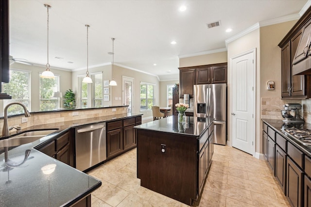 21307 Plum Gate Ct, Richmond, TX 77407 - kitchen with appliances with stainless steel finishes, a sink, recessed lighting, tasteful backsplash, and dark brown cabinets