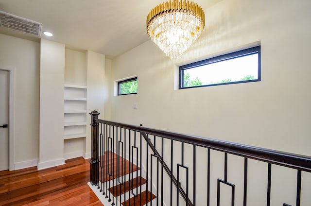 3626 Dreyfus St, Houston, TX 77021 - hallway with an upstairs landing, plenty of natural light, wood finished floors, a chandelier, and recessed lighting