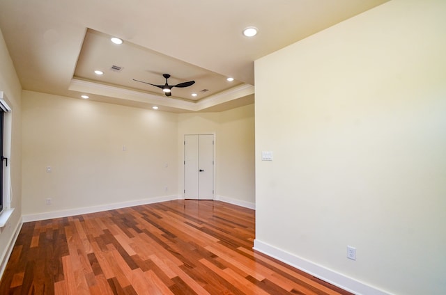 3626 Dreyfus St, Houston, TX 77021 - spare room with a tray ceiling, a ceiling fan, wood finished floors, baseboards, and crown molding