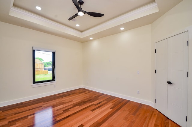 3626 Dreyfus St, Houston, TX 77021 - spare room featuring crown molding, a tray ceiling, light wood-type flooring, a ceiling fan, and recessed lighting