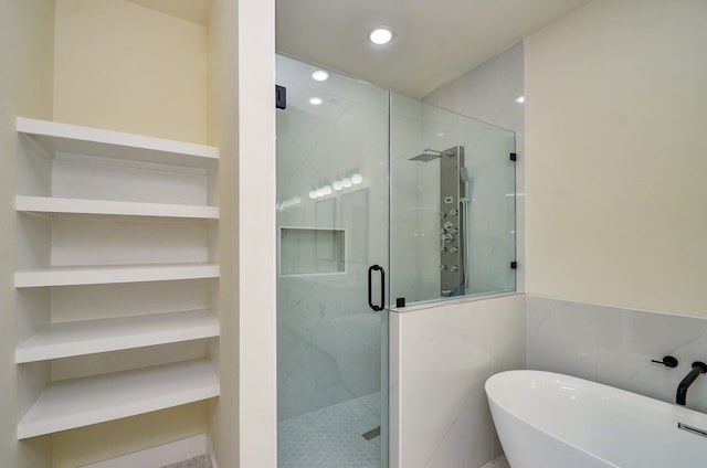 3626 Dreyfus St, Houston, TX 77021 - bathroom featuring a freestanding bath, a stall shower, built in shelves, recessed lighting, and tile walls