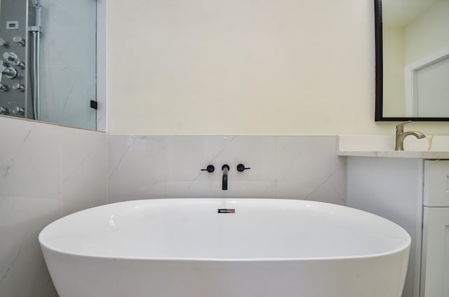 3626 Dreyfus St, Houston, TX 77021 - bathroom with a freestanding tub, vanity, and tile walls