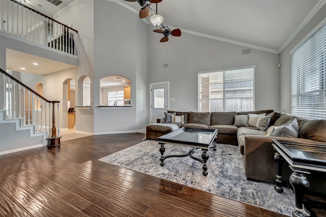 17815 Gables Bend Dr, Tomball, TX 77377 - living room with wood finished floors, baseboards, stairs, high vaulted ceiling, and arched walkways
