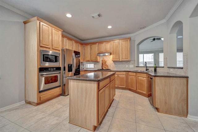 17815 Gables Bend Dr, Tomball, TX 77377 - kitchen with appliances with stainless steel finishes, a sink, ornamental molding, a center island, and decorative backsplash