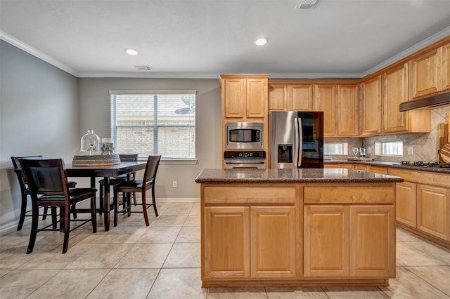 17815 Gables Bend Dr, Tomball, TX 77377 - kitchen with stainless steel appliances, crown molding, baseboards, a kitchen island, and tasteful backsplash