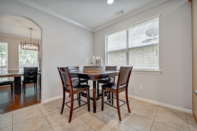 17815 Gables Bend Dr, Tomball, TX 77377 - dining space with healthy amount of natural light, arched walkways, crown molding, and baseboards