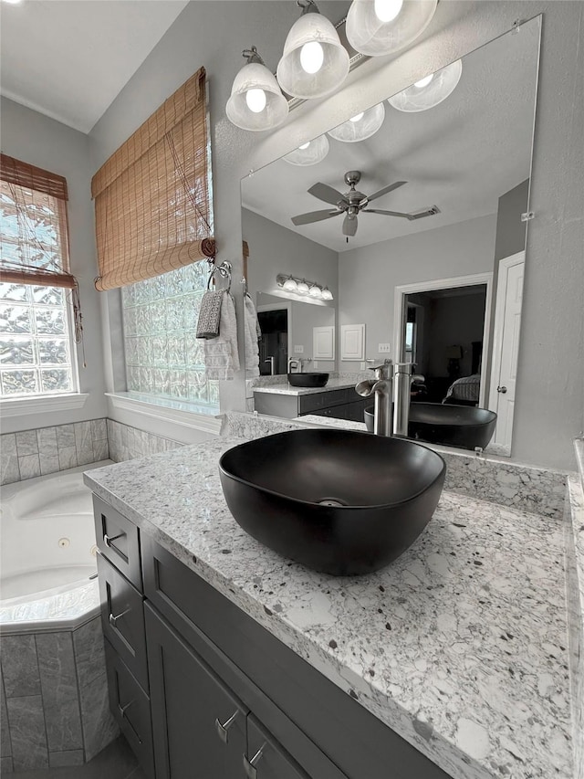 17815 Gables Bend Dr, Tomball, TX 77377 - kitchen with a sink, a ceiling fan, and light stone counters