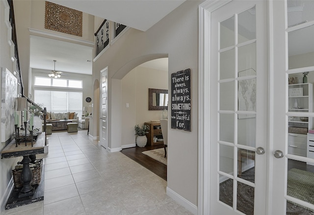 13705 Northline Lake Dr, Houston, TX 77044 - hallway with arched walkways, tile patterned floors, and baseboards