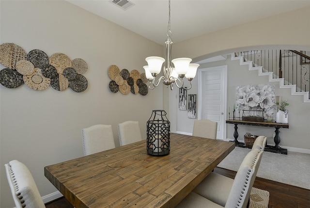 13705 Northline Lake Dr, Houston, TX 77044 - dining room with arched walkways, a chandelier, radiator heating unit, baseboards, and dark wood finished floors