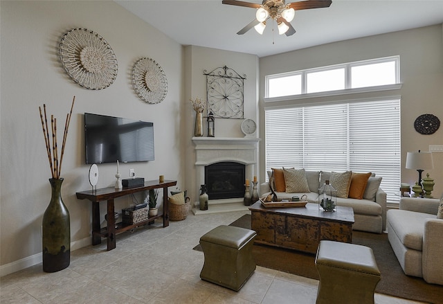13705 Northline Lake Dr, Houston, TX 77044 - living room featuring light tile patterned flooring, a ceiling fan, a glass covered fireplace, and baseboards