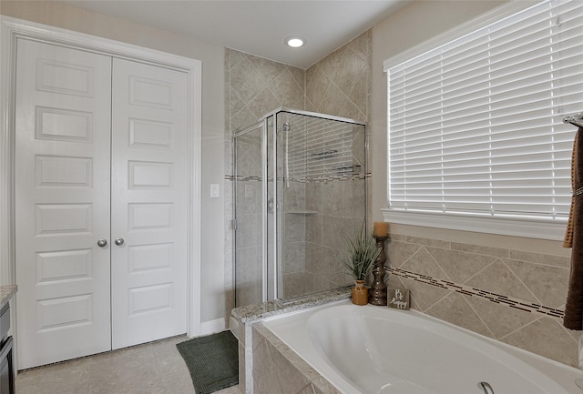 13705 Northline Lake Dr, Houston, TX 77044 - full bathroom with a garden tub, a shower stall, tile patterned floors, and vanity