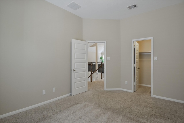 13705 Northline Lake Dr, Houston, TX 77044 - unfurnished bedroom with carpet flooring, a walk in closet, and baseboards
