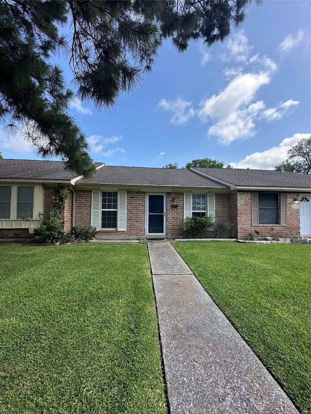 2316 Buchanan Dr, Baytown, TX 77520 - ranch-style house featuring brick siding and a front yard