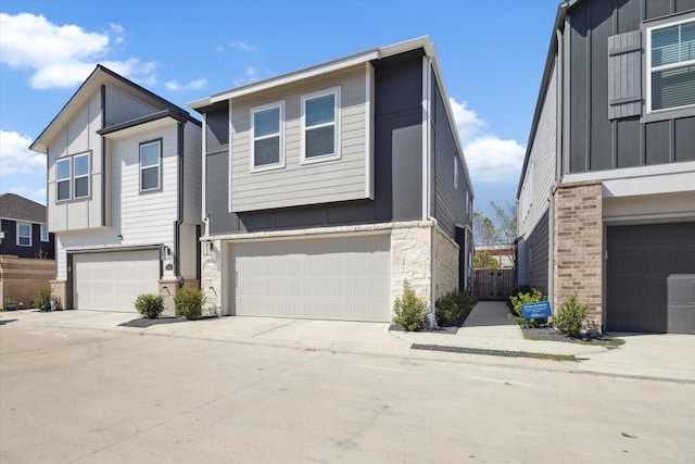 9954 Storehouse Dr, Houston, TX 77080 - modern home with stone siding, an attached garage, and concrete driveway
