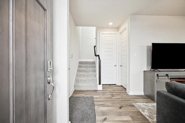 9954 Storehouse Dr, Houston, TX 77080 - entrance foyer featuring baseboards, light wood-style floors, recessed lighting, and stairs