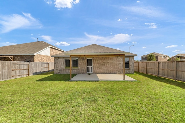 1491 Twilight Green Dr, Katy, TX 77493 - back of property featuring a patio area, brick siding, and roof with shingles