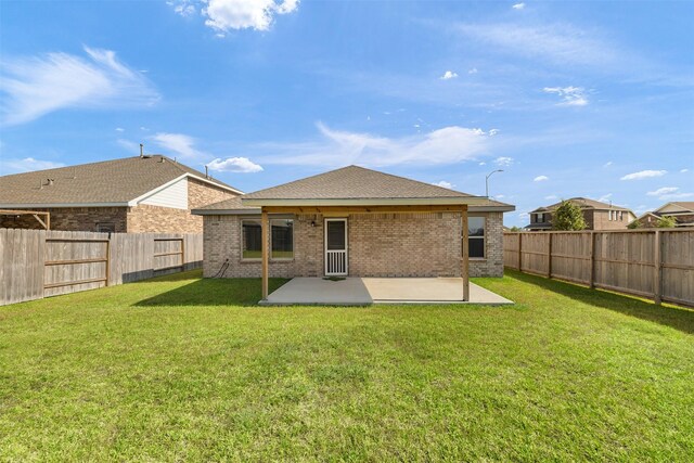 1491 Twilight Green Dr, Katy, TX 77493 - back of property featuring a patio area, brick siding, and roof with shingles