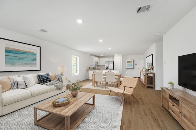 1491 Twilight Green Dr, Katy, TX 77493 - living area featuring light wood finished floors and recessed lighting