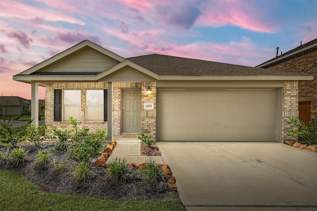 1491 Twilight Green Dr, Katy, TX 77493 - view of front of house with driveway, an attached garage, brick siding, and roof with shingles
