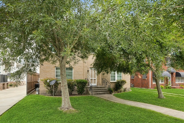 4404 Avenue N 1/2 Ave N 1/2, Galveston, TX 77550 - view of property hidden behind natural elements featuring brick siding