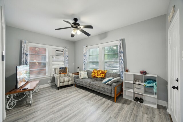 4404 Avenue N 1/2 Ave N 1/2, Galveston, TX 77550 - living room with baseboards, wood finished floors, ceiling fan, and a wall mounted air conditioner