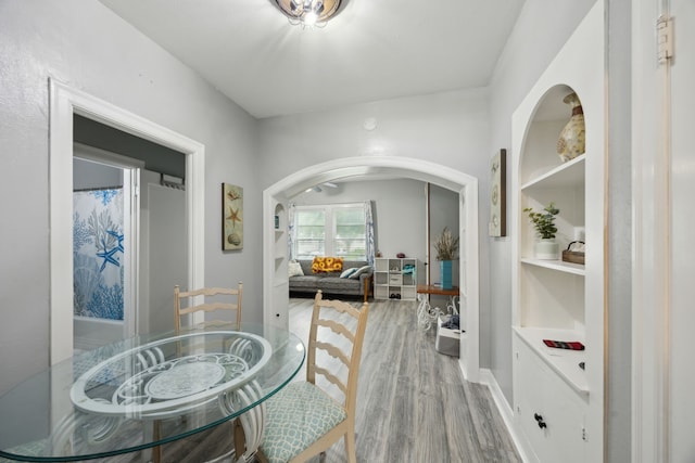 4404 Avenue N 1/2 Ave N 1/2, Galveston, TX 77550 - dining space featuring arched walkways, wood finished floors, baseboards, and built in shelves