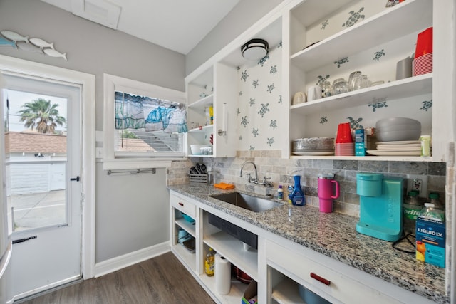 4404 Avenue N 1/2 Ave N 1/2, Galveston, TX 77550 - kitchen featuring open shelves, a sink, decorative backsplash, light stone counters, and dark wood-type flooring