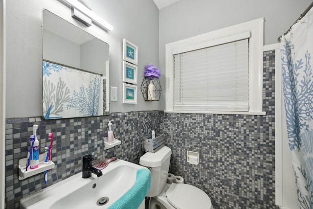 4404 Avenue N 1/2 Ave N 1/2, Galveston, TX 77550 - bathroom featuring toilet, a sink, tile walls, and a shower with curtain