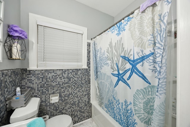 4404 Avenue N 1/2 Ave N 1/2, Galveston, TX 77550 - bathroom featuring toilet, shower / bathtub combination with curtain, tile walls, and wainscoting