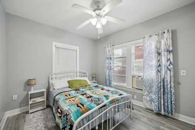 4404 Avenue N 1/2 Ave N 1/2, Galveston, TX 77550 - bedroom featuring baseboards, wood finished floors, and ceiling fan