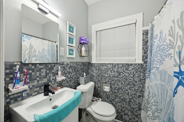 4404 Avenue N 1/2 Ave N 1/2, Galveston, TX 77550 - full bath with toilet, tile walls, a sink, wainscoting, and a shower with curtain