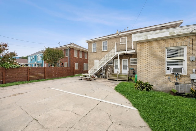4404 Avenue N 1/2 Ave N 1/2, Galveston, TX 77550 - view of building exterior featuring uncovered parking, cooling unit, central air condition unit, and stairway