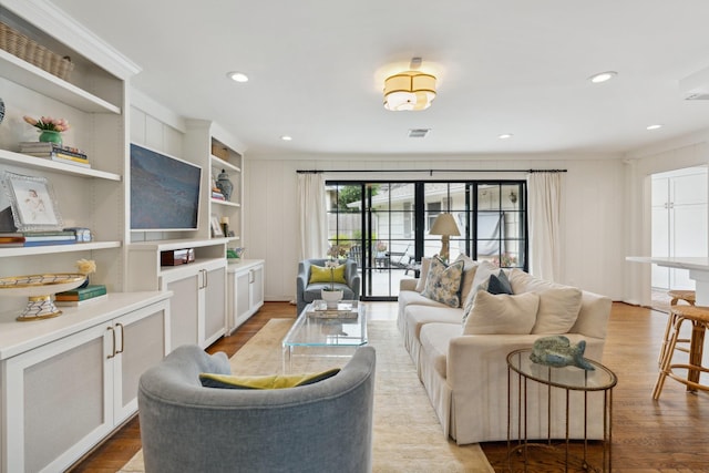6147 Chevy Chase Dr, Houston, TX 77057 - living room featuring light wood finished floors, recessed lighting, and crown molding