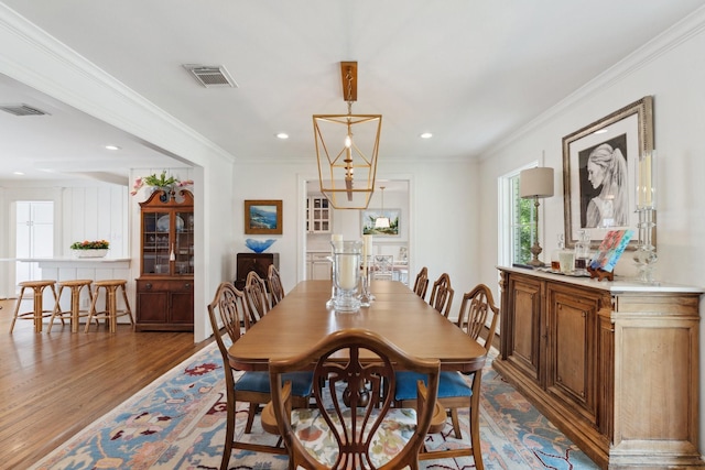 6147 Chevy Chase Dr, Houston, TX 77057 - dining room with wood finished floors, ornamental molding, and recessed lighting