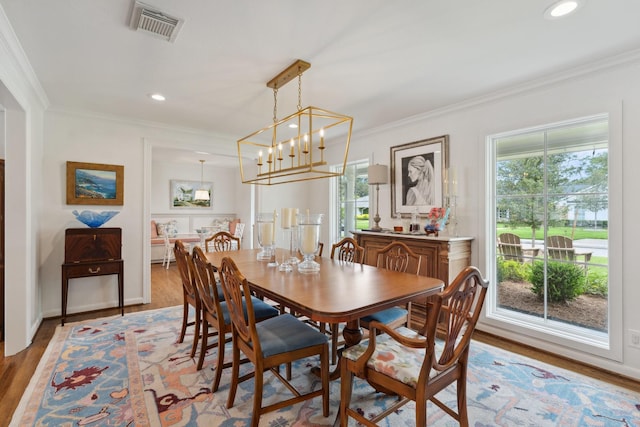 6147 Chevy Chase Dr, Houston, TX 77057 - dining room featuring wood finished floors, ornamental molding, recessed lighting, a chandelier, and baseboards