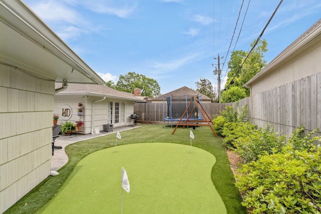 6147 Chevy Chase Dr, Houston, TX 77057 - fenced backyard featuring a putting area and a trampoline