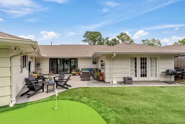 6147 Chevy Chase Dr, Houston, TX 77057 - rear view of property with an area to practice putting, a patio area, roof with shingles, and a yard