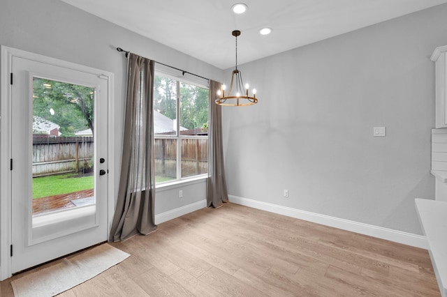 10 Hollylaurel Dr, The Woodlands, TX 77382 - unfurnished dining area featuring a chandelier, light wood finished floors, baseboards, and recessed lighting