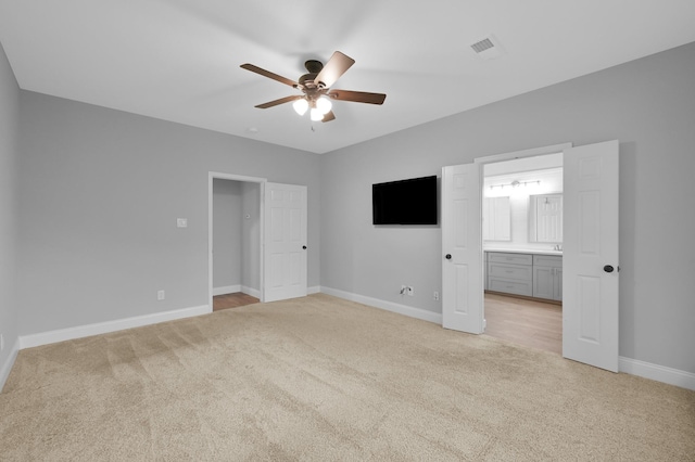 10 Hollylaurel Dr, The Woodlands, TX 77382 - unfurnished bedroom with light carpet, baseboards, connected bathroom, and ceiling fan