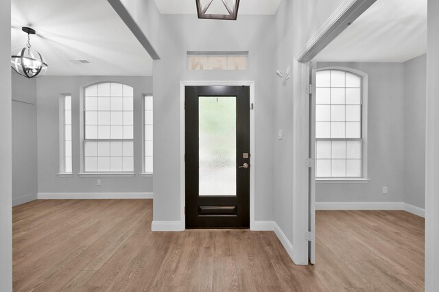 10 Hollylaurel Dr, The Woodlands, TX 77382 - entryway featuring a chandelier, wood finished floors, and baseboards
