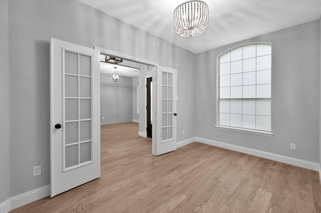 10 Hollylaurel Dr, The Woodlands, TX 77382 - spare room with a chandelier and baseboards