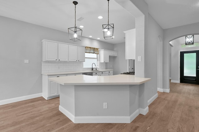 10 Hollylaurel Dr, The Woodlands, TX 77382 - kitchen featuring light countertops, backsplash, white cabinets, light wood finished floors, and recessed lighting