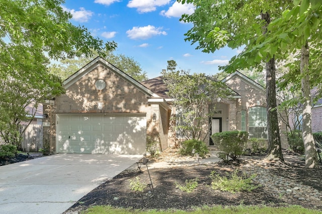 10 Hollylaurel Dr, The Woodlands, TX 77382 - view of front of house featuring brick siding, an attached garage, and driveway