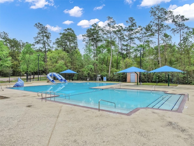 10 Hollylaurel Dr, The Woodlands, TX 77382 - community pool with a patio area and view of wooded area