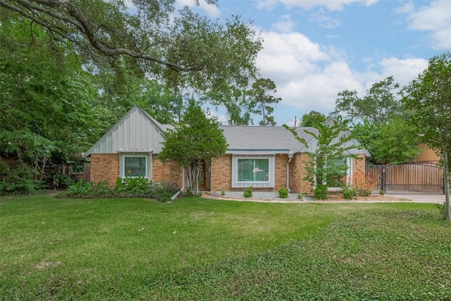 10126 Whiteside Ln, Houston, TX 77043 - single story home with brick siding, a gate, a front lawn, and board and batten siding